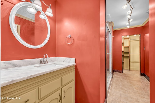 bathroom with an enclosed shower, crown molding, and vanity