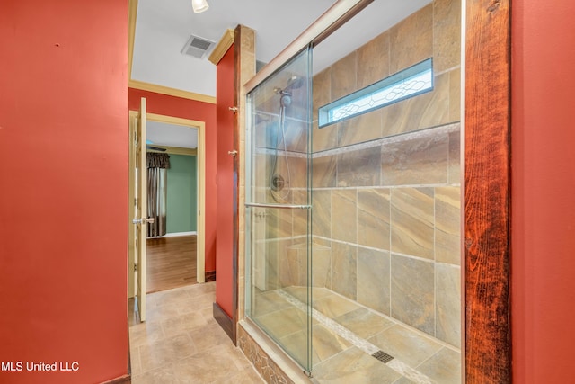 full bathroom with a stall shower, tile patterned flooring, and visible vents