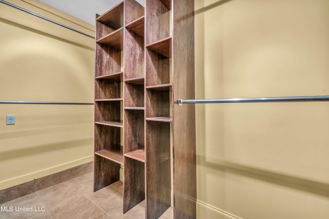 spacious closet featuring light tile patterned floors