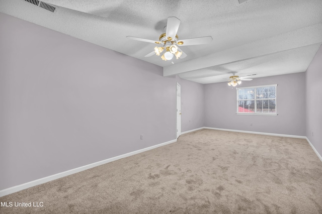 unfurnished room with visible vents, baseboards, ceiling fan, carpet, and a textured ceiling