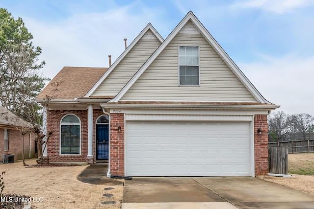 traditional-style home featuring a garage, concrete driveway, brick siding, and central AC