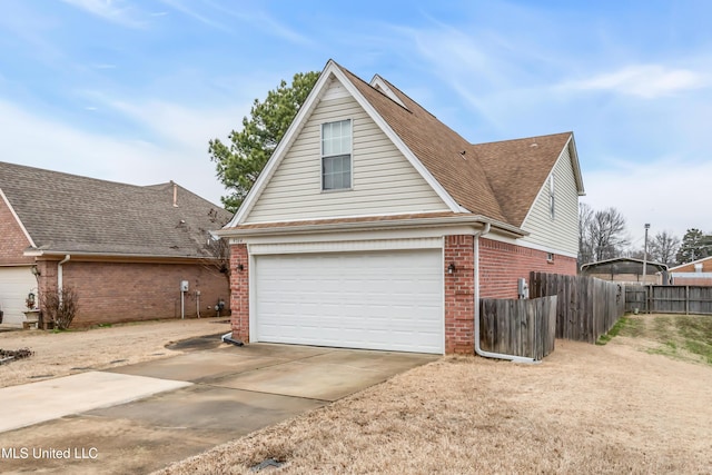 view of front of home with a garage, brick siding, fence, and driveway