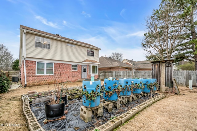 view of pool with a garden and a fenced backyard