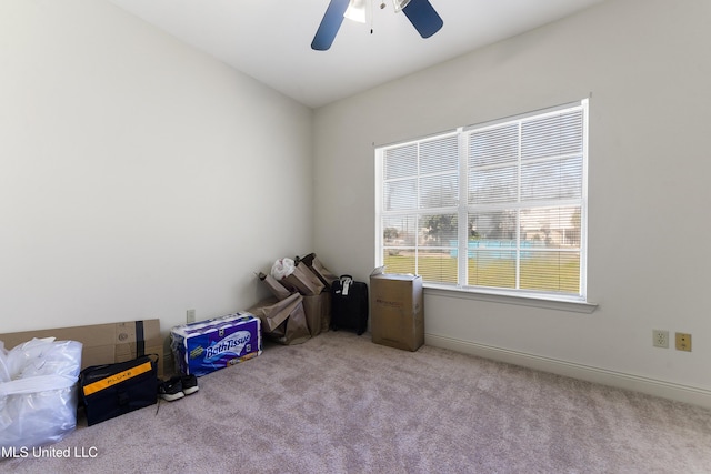 empty room featuring ceiling fan, baseboards, and carpet flooring