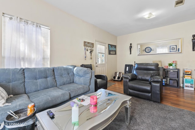 living room featuring visible vents and wood finished floors