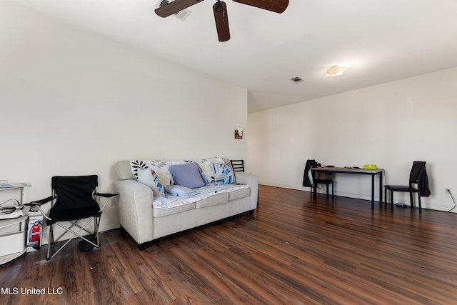 living area featuring a ceiling fan, visible vents, baseboards, and wood finished floors