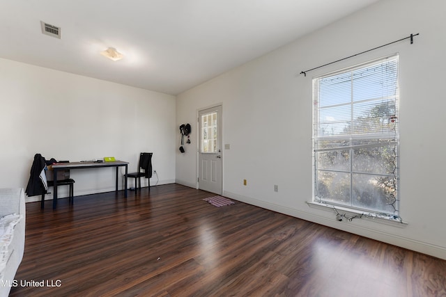 entrance foyer featuring dark wood finished floors, visible vents, and baseboards