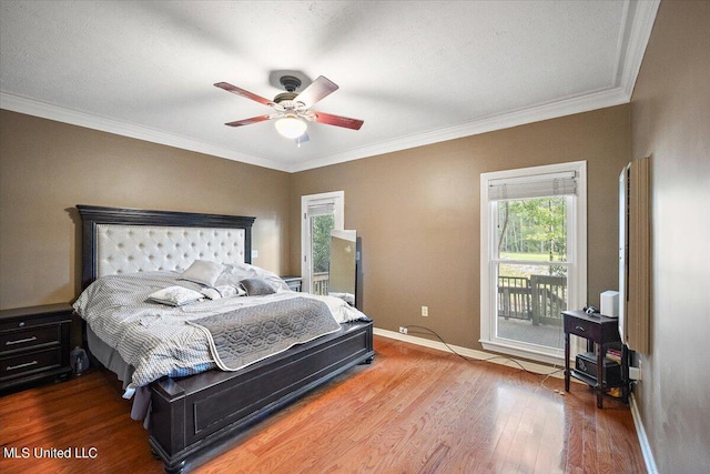 bedroom featuring ceiling fan, ornamental molding, and hardwood / wood-style floors