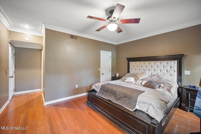 bedroom featuring ceiling fan, crown molding, and wood-type flooring