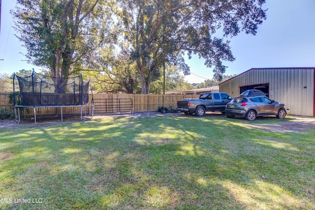 view of yard featuring an outdoor structure and a trampoline