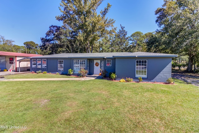 ranch-style home featuring a carport and a front yard