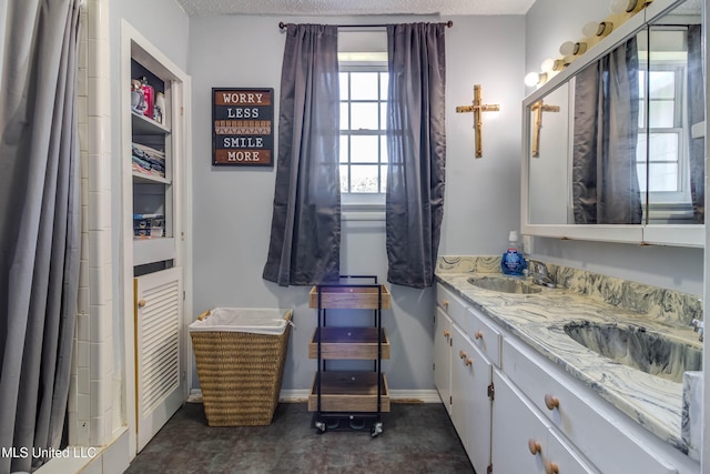 bathroom with vanity and a textured ceiling