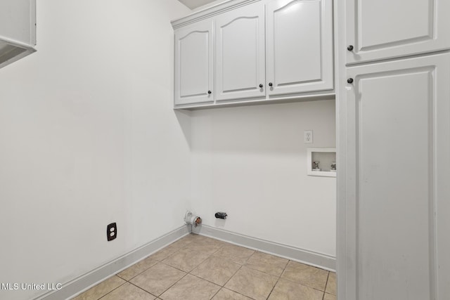 laundry room with cabinets, washer hookup, and light tile patterned floors