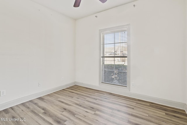 empty room featuring ceiling fan and light hardwood / wood-style flooring