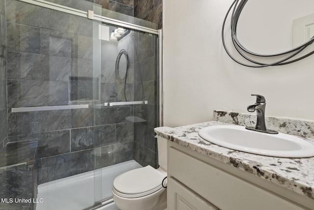 bathroom with vanity, toilet, and walk in shower