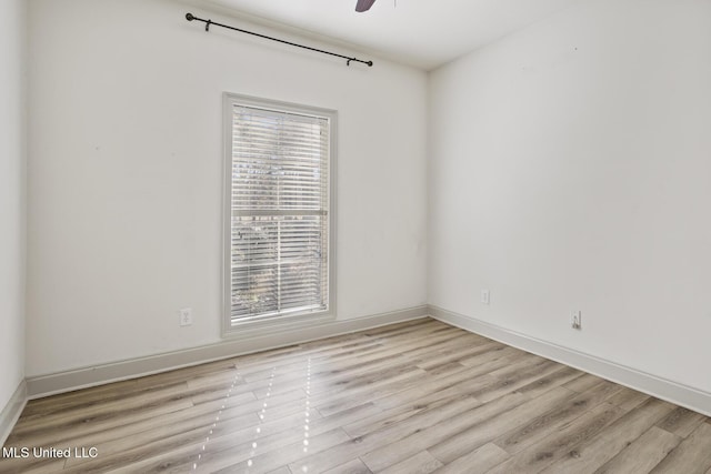 spare room with light hardwood / wood-style floors and ceiling fan