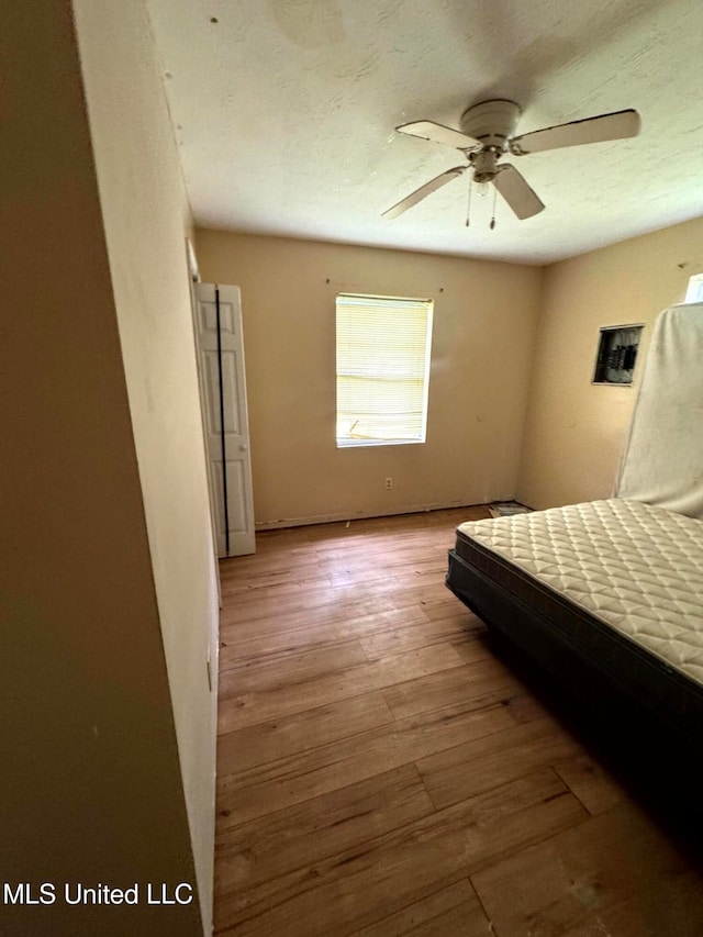 unfurnished bedroom featuring light wood-type flooring and ceiling fan