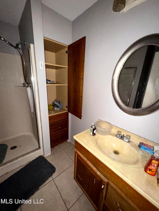 bathroom with vanity, tile patterned floors, and walk in shower