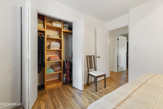 1215 23rd St, Gulfport, MS 39501 - bedroom featuring wood finished floors, a closet, and a walk in closet