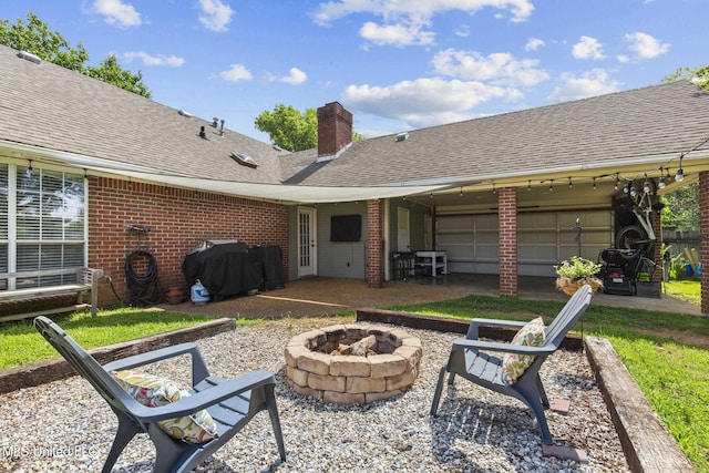 215 Cobblestone Dr, Madison, MS 39110 - view of patio / terrace with a fire pit, an attached garage, and area for grilling