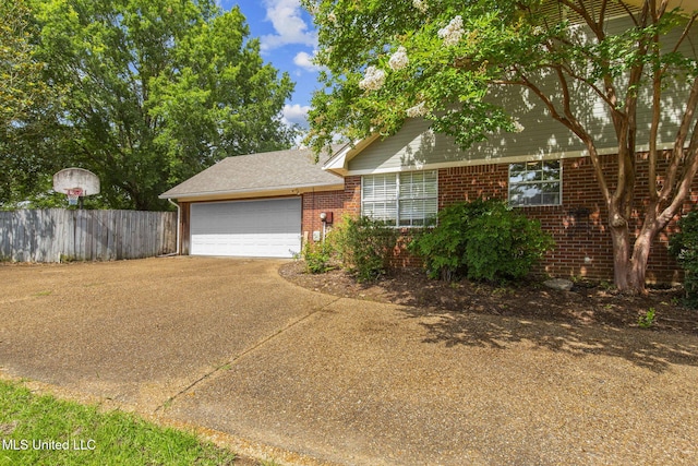 215 Cobblestone Dr, Madison, MS 39110 - obstructed view of property with brick siding, concrete driveway, and an attached garage