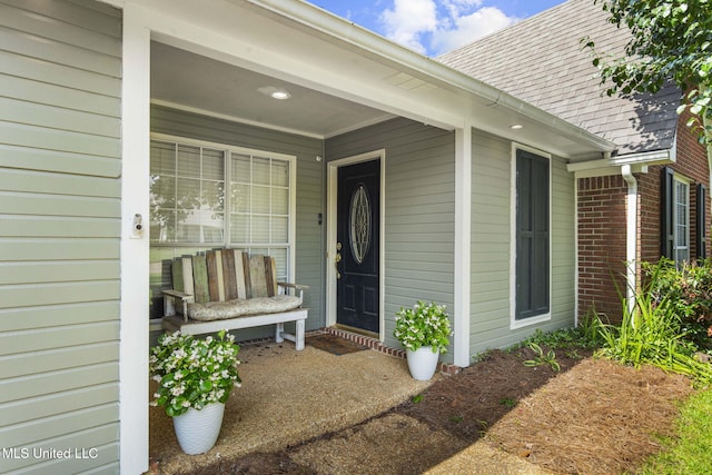 215 Cobblestone Dr, Madison, MS 39110 - entrance to property with roof with shingles, brick siding, and a porch
