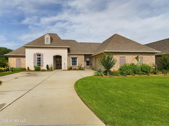 view of front of property with a front yard and a garage