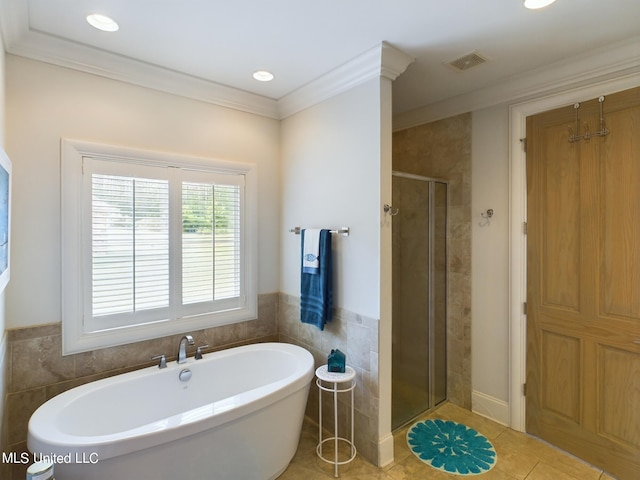 bathroom featuring separate shower and tub, tile patterned floors, tile walls, and ornamental molding