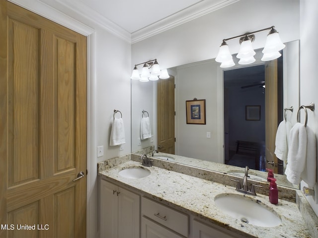 bathroom with crown molding, vanity, and ceiling fan