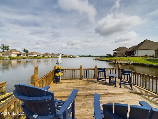 dock area featuring a deck with water view