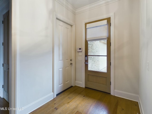 doorway to outside featuring crown molding and light hardwood / wood-style flooring