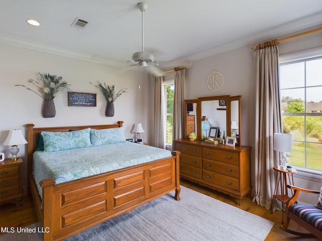 bedroom featuring wood-type flooring, ceiling fan, and ornamental molding