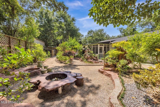 2085 Pat Ln, Biloxi, MS 39531 - fenced backyard with a fire pit and a sunroom