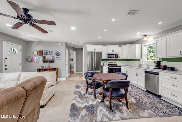 2085 Pat Ln, Biloxi, MS 39531 - kitchen with stainless steel appliances, open floor plan, recessed lighting, light countertops, and white cabinets