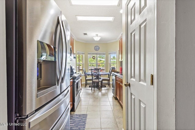 21915 Huntington Forest Dr, Saucier, MS 39574 - kitchen with appliances with stainless steel finishes, crown molding, brown cabinets, and light tile patterned flooring
