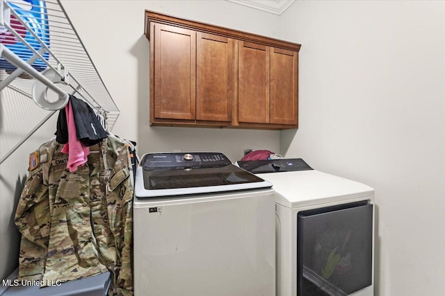21915 Huntington Forest Dr, Saucier, MS 39574 - washroom with washer and clothes dryer and cabinet space