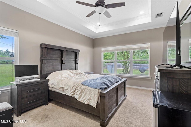 21915 Huntington Forest Dr, Saucier, MS 39574 - bedroom featuring ornamental molding, light carpet, a tray ceiling, a ceiling fan, and baseboards