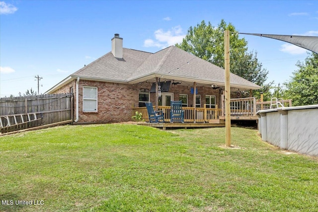 21915 Huntington Forest Dr, Saucier, MS 39574 - back of house with a wooden deck, a ceiling fan, a chimney, and brick siding