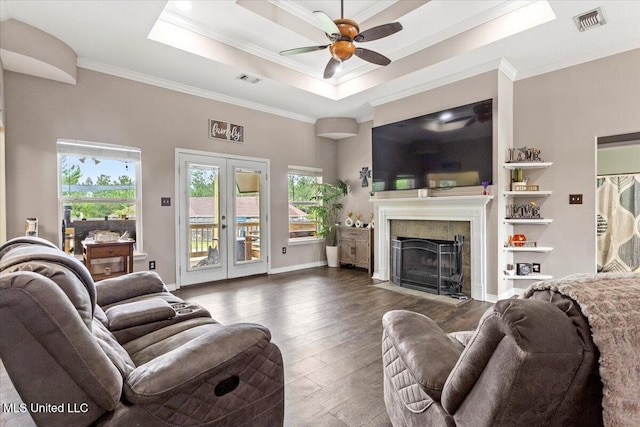 21915 Huntington Forest Dr, Saucier, MS 39574 - living room featuring ornamental molding, hardwood / wood-style flooring, a ceiling fan, a fireplace with flush hearth, and a tray ceiling