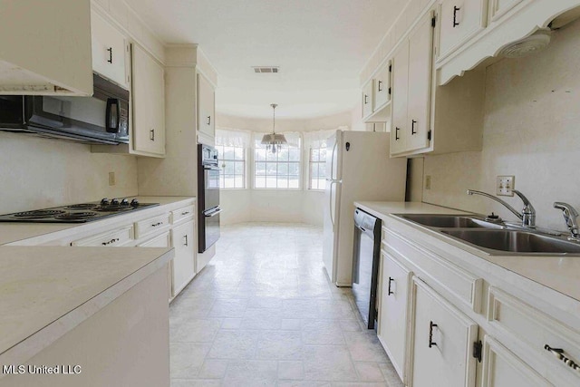 kitchen with visible vents, a sink, light countertops, black appliances, and a chandelier