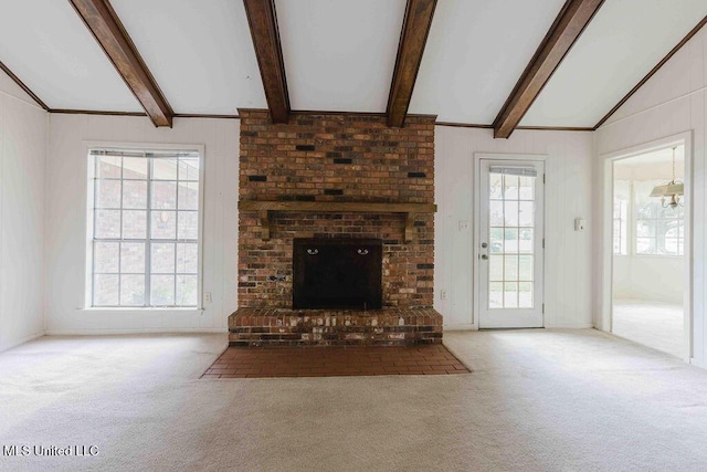 unfurnished living room featuring carpet floors, a brick fireplace, and vaulted ceiling with beams