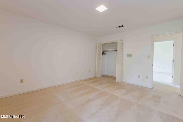 unfurnished bedroom with visible vents, baseboards, and light carpet
