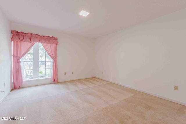 carpeted empty room with baseboards