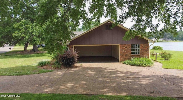 view of front of home with a garage, a front lawn, and concrete driveway