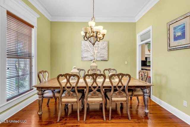 769 Mclane Ln, Biloxi, MS 39532 - dining room with a chandelier, wood finished floors, and ornamental molding