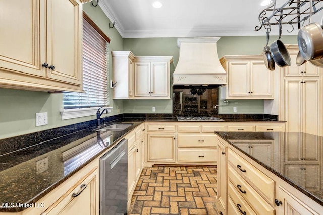 769 Mclane Ln, Biloxi, MS 39532 - kitchen with custom range hood, stainless steel appliances, brick patterned floors, cream cabinets, and ornamental molding