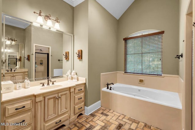 769 Mclane Ln, Biloxi, MS 39532 - bathroom featuring brick floors, a garden tub, vanity, and vaulted ceiling