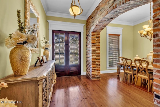 769 Mclane Ln, Biloxi, MS 39532 - entrance foyer with french doors, wood-type flooring, healthy amount of natural light, ornamental molding, and a chandelier