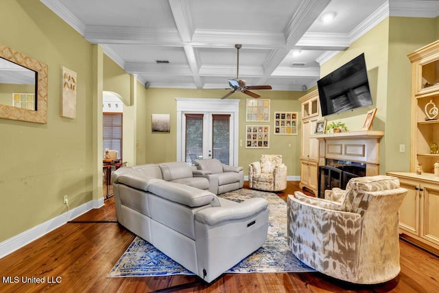 769 Mclane Ln, Biloxi, MS 39532 - living area with wood-type flooring, ceiling fan, a fireplace, beamed ceiling, and ornamental molding