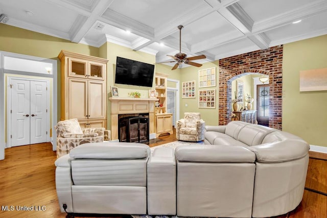 769 Mclane Ln, Biloxi, MS 39532 - living room with light wood-style floors, ceiling fan, a fireplace, coffered ceiling, and beam ceiling